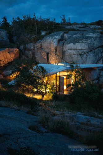 House with transparent walls on sunny rocky shores in Sandefjord, Norway