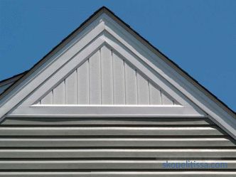 Roof gable, wooden gable, decoration of the gable and mansard roof of a private house