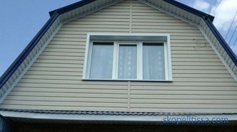 Roof gable, wooden gable, decoration of the gable and mansard roof of a private house